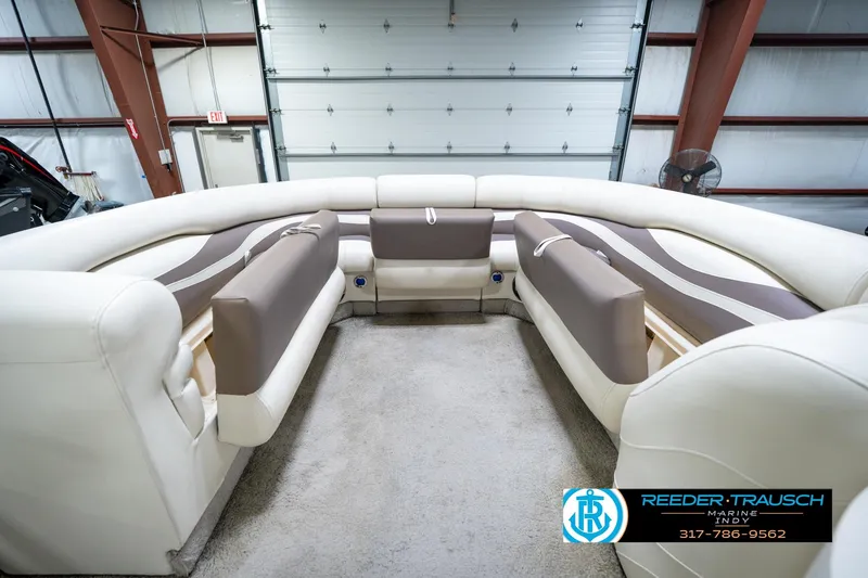 Slide: The Image of 2008 Bennington 20 SL boat interior with plush seating in a spacious garage setting. - 20