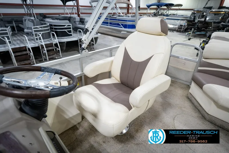 Slide: The Image of 2008 Bennington 20 SL boat interior with beige and brown captain's chair and steering wheel. - 33