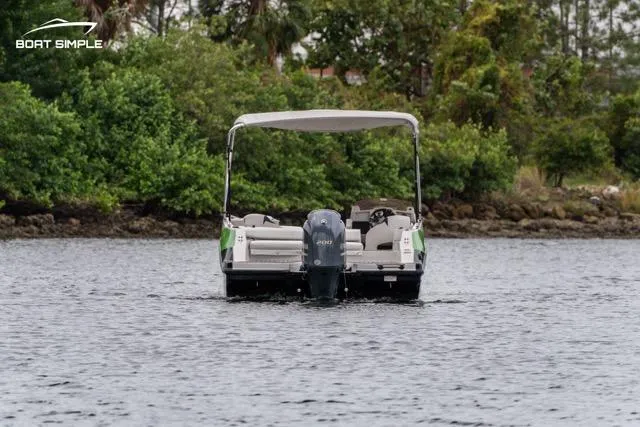 Slide: The Image of 2023 Starcraft SVX 231 OB DH boat on water, surrounded by lush greenery. - 4