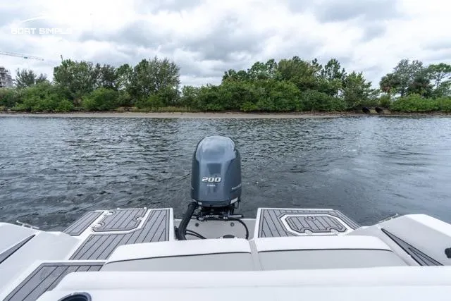 Slide: The Image of 2023 Starcraft SVX 231 OB DH boat on water, rear view with outboard motor. - 7