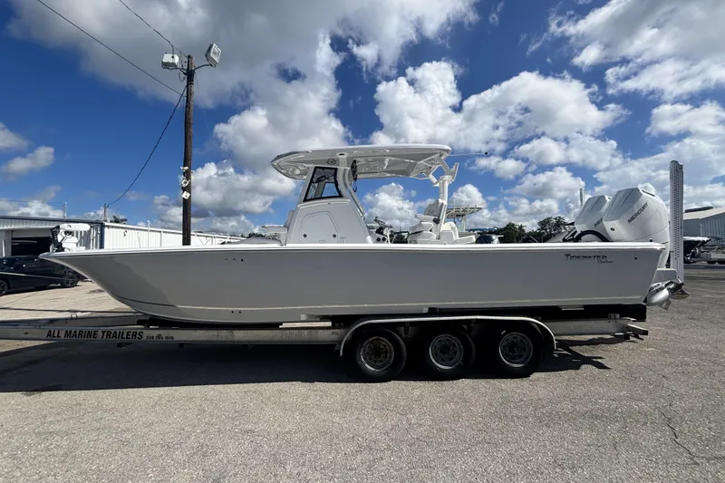 The Image of 2026 Tidewater 3100 Carolina Bay boat on trailer under a blue sky. - 0