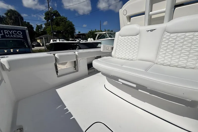 Slide: The Image of 2026 Tidewater 3100 Carolina Bay boat interior with white seating and storage compartments. - 14