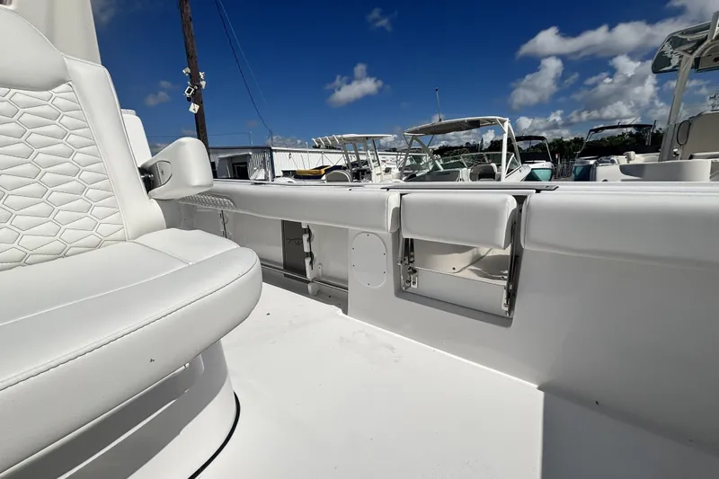 Slide: The Image of 2026 Tidewater 3100 Carolina Bay boat interior with white seating and clear blue sky. - 15
