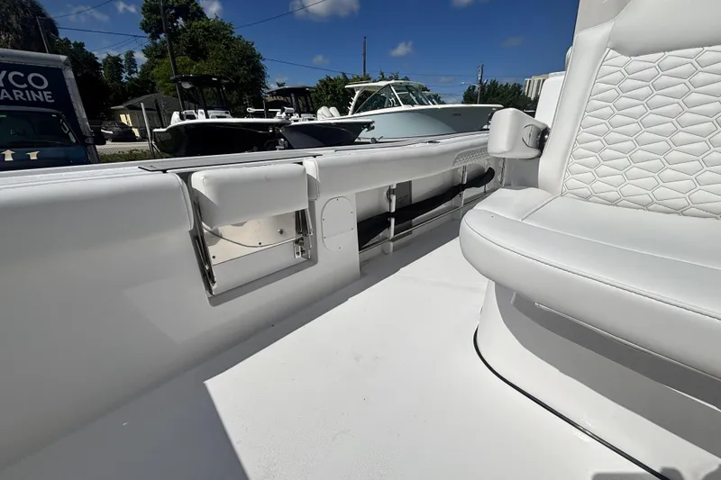Slide: The Image of 2026 Tidewater 3100 Carolina Bay boat interior with white seating and storage compartments. - 16