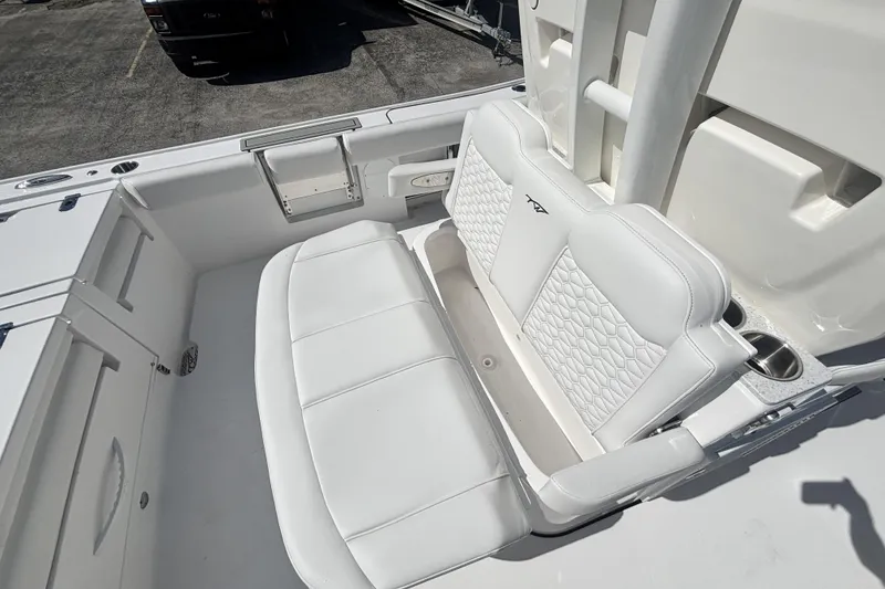 Slide: The Image of 2026 Tidewater 3100 Carolina Bay boat with white cushioned seating and cup holders. - 17