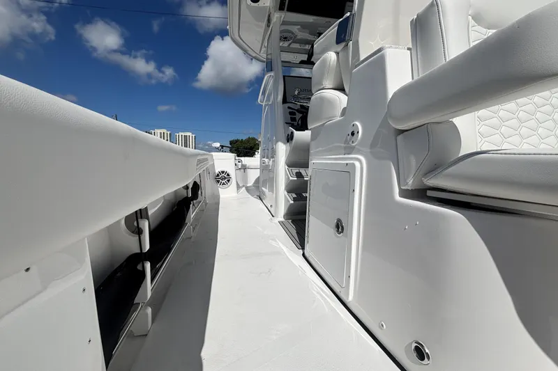 Slide: The Image of 2026 Tidewater 3100 Carolina Bay boat interior with white seating and storage compartments. - 18