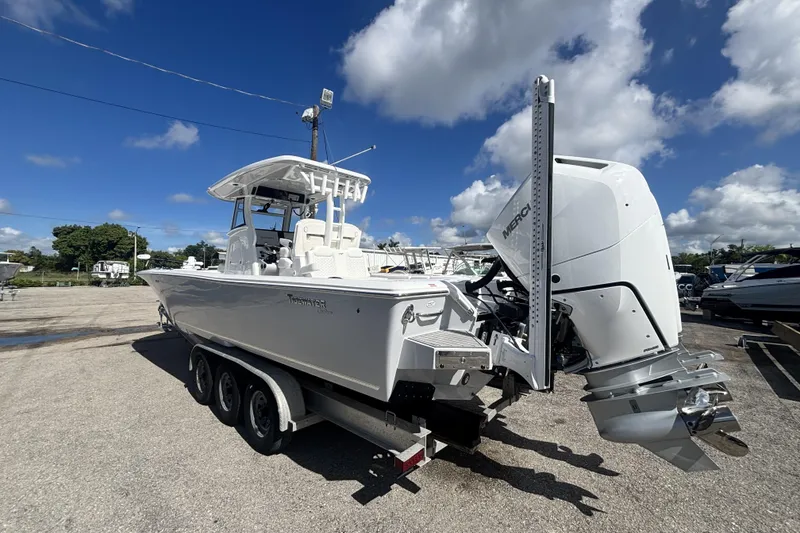 Slide: The Image of 2026 Tidewater 3100 Carolina Bay boat with powerful outboard motor on a trailer. - 2