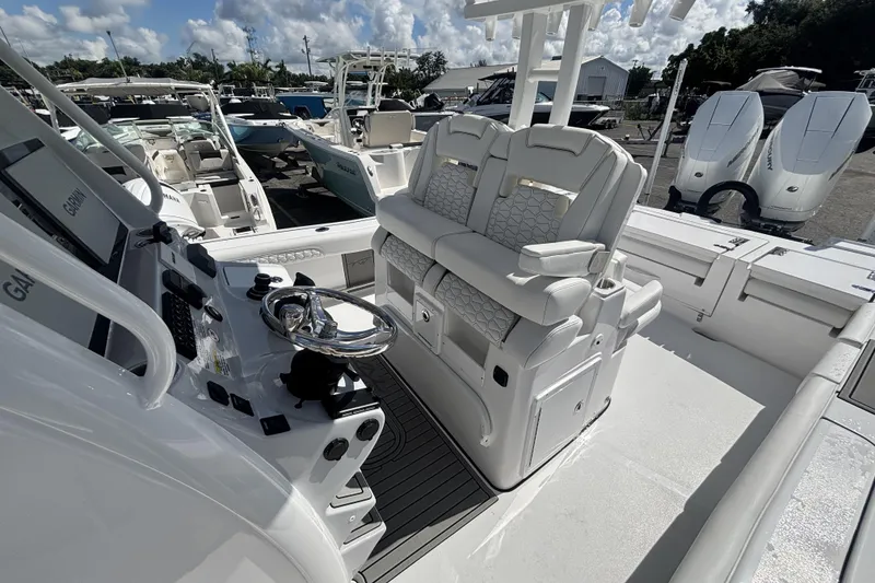 Slide: The Image of 2026 Tidewater 3100 Carolina Bay boat interior with dual seats and control panel. - 20