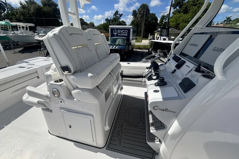 Slide: The Image of 2026 Tidewater 3100 Carolina Bay boat interior with dual seats and control panel. - 22