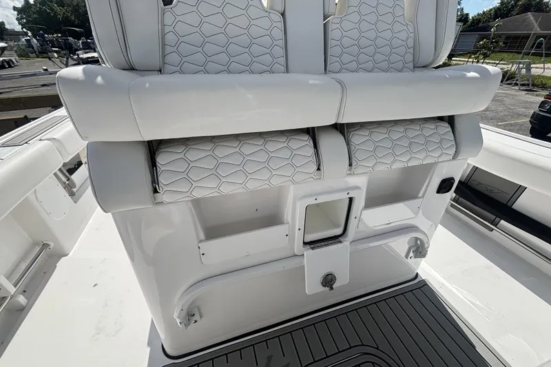 Slide: The Image of 2026 Tidewater 3100 Carolina Bay boat interior with white cushioned seating and storage compartments. - 23
