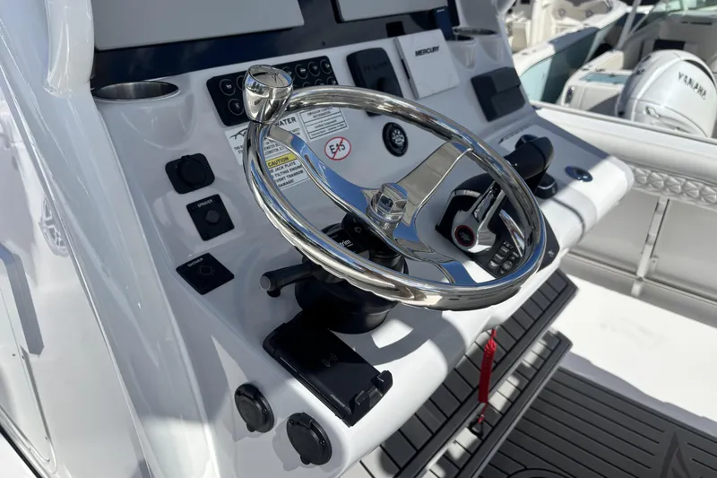 Slide: The Image of 2026 Tidewater 3100 Carolina Bay boat helm with steering wheel and controls. - 26