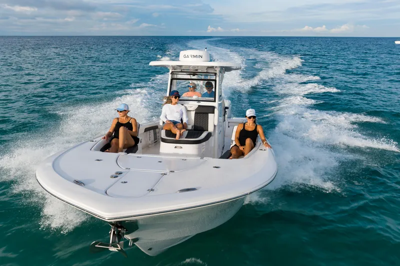 Slide: The Image of 2026 Tidewater 3100 Carolina Bay boat cruising with passengers on open water. - 32