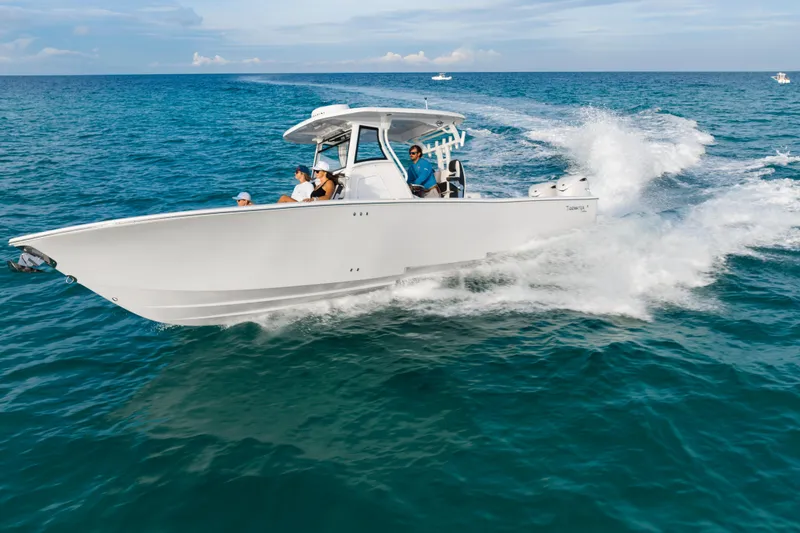 Slide: The Image of 2026 Tidewater 3100 Carolina Bay boat cruising on open ocean waters. - 33