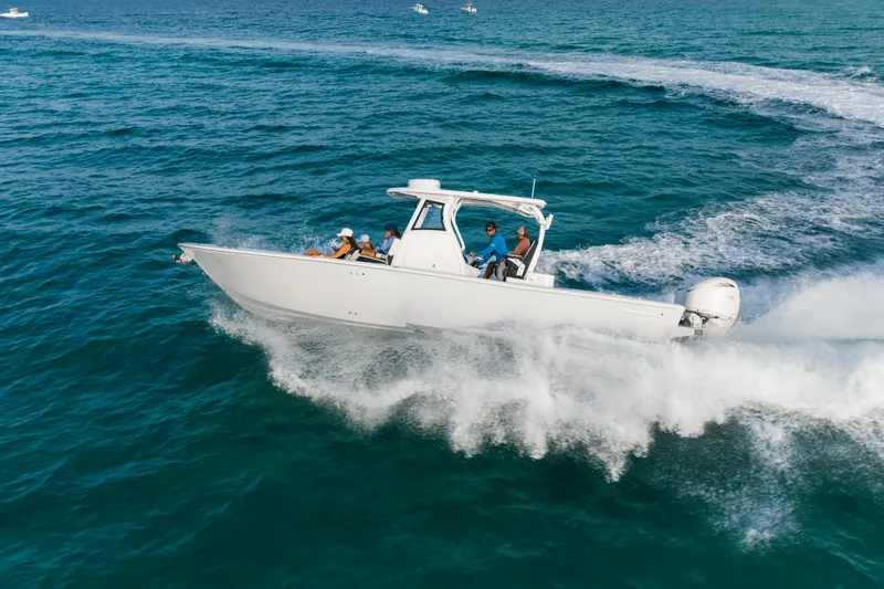 Slide: The Image of 2026 Tidewater 3100 Carolina Bay boat cruising on open ocean waters. - 34