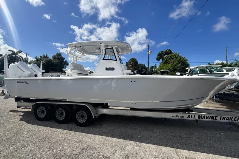 Slide: The Image of 2026 Tidewater 3100 Carolina Bay boat on trailer under blue sky. - 4