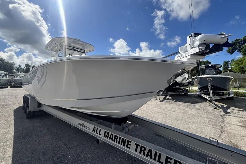Slide: The Image of 2026 Tidewater 3100 Carolina Bay boat on trailer under blue sky. - 7