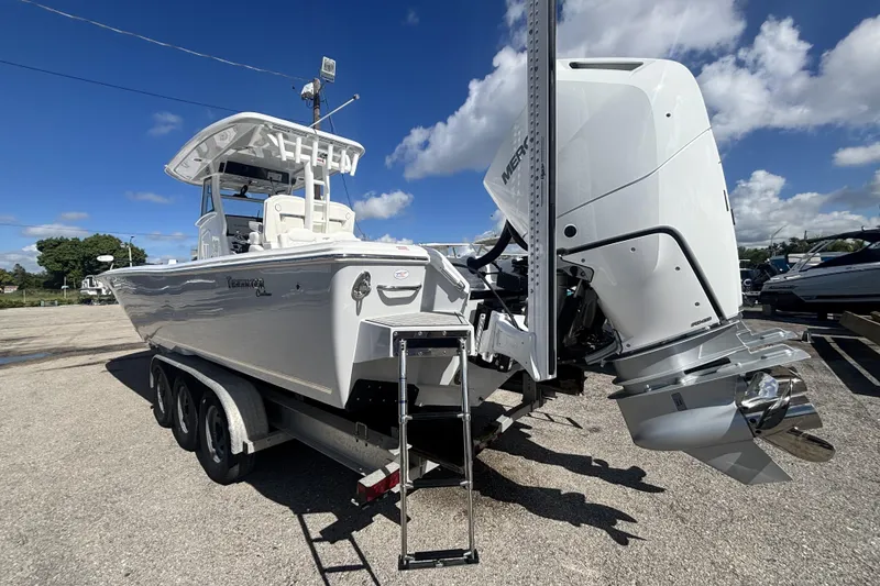 Slide: The Image of 2026 Tidewater 3100 Carolina Bay boat with powerful outboard motor on a trailer. - 8