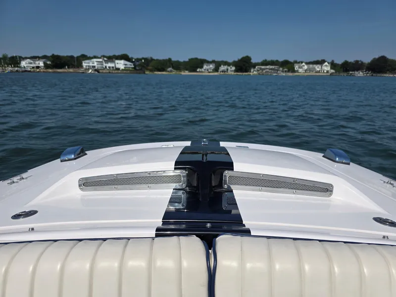 Slide: The Image of 2018 Donzi 22 Classic boat on calm water with shoreline view. - 10