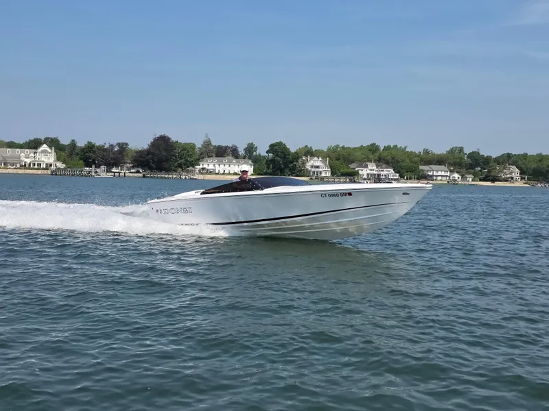 Slide: The Image of 2018 Donzi 22 Classic speedboat cruising on a scenic lake. - 16