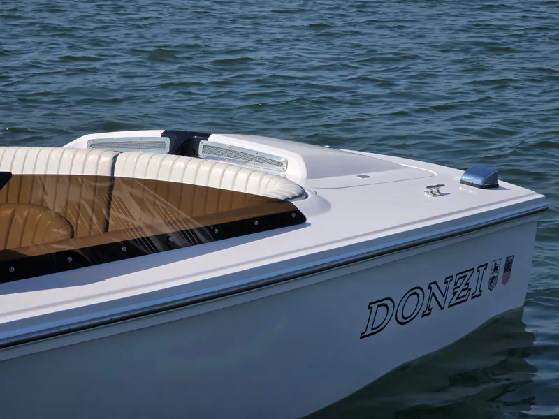 Slide: The Image of 2018 Donzi 22 Classic boat on water, featuring sleek white design and comfortable seating. - 4
