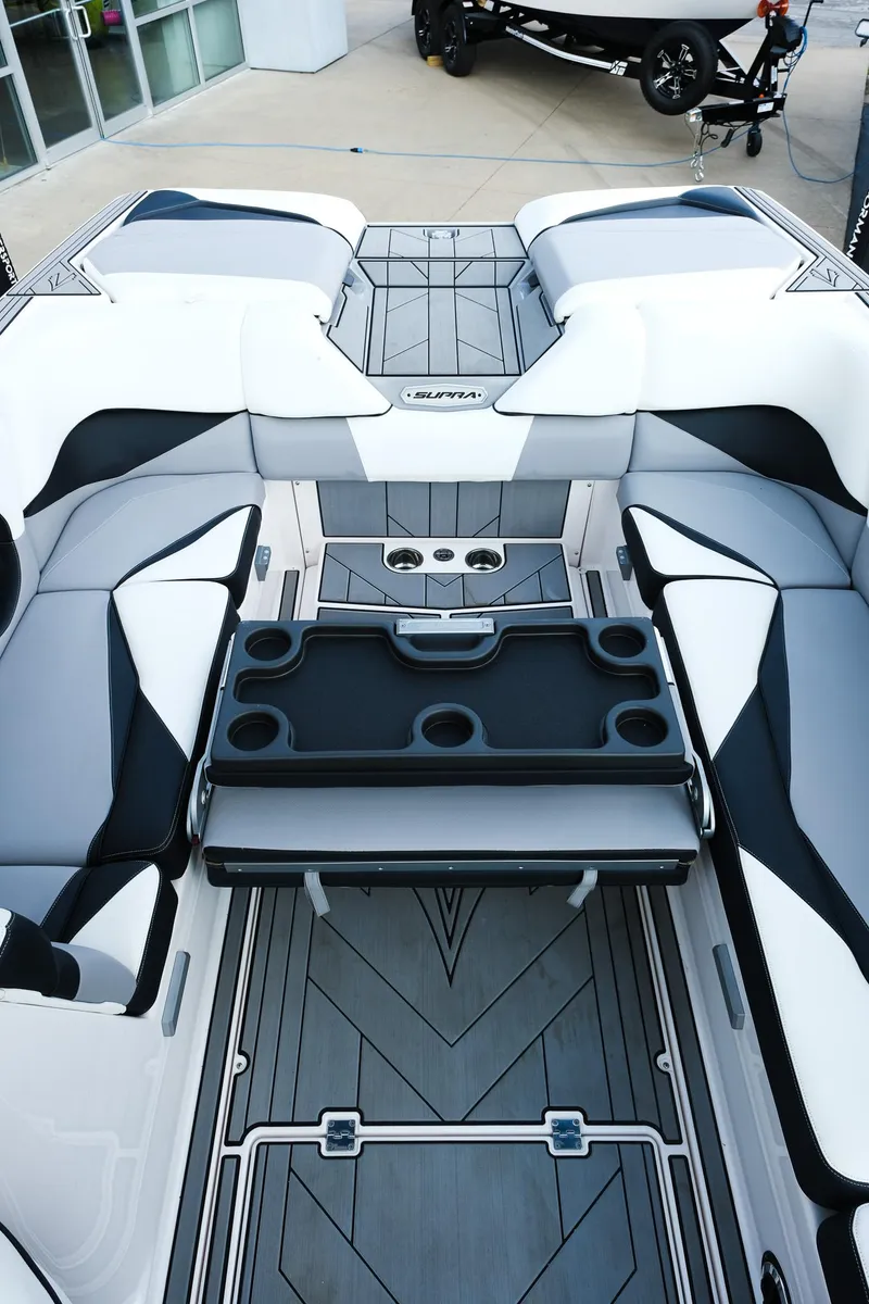 Slide: The Image of 2020 Supra SL450 boat interior with sleek seating and cup holders. - 14