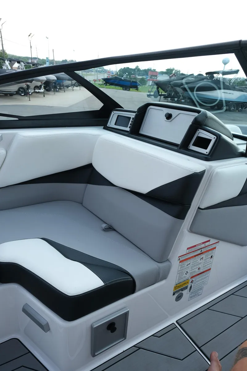 Slide: The Image of 2020 Supra SL450 boat interior with sleek black and white seating design. - 18