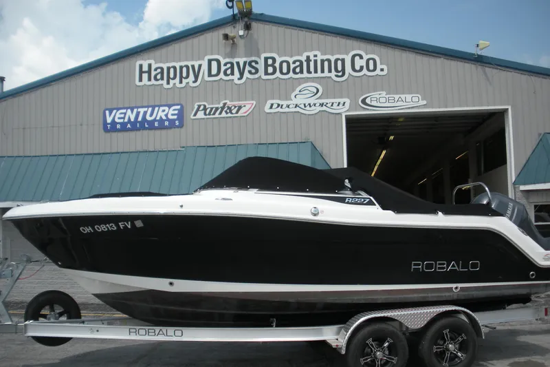 The Image of 2017 Robalo R227DC boat on trailer at Happy Days Boating Co. dealership. - 0