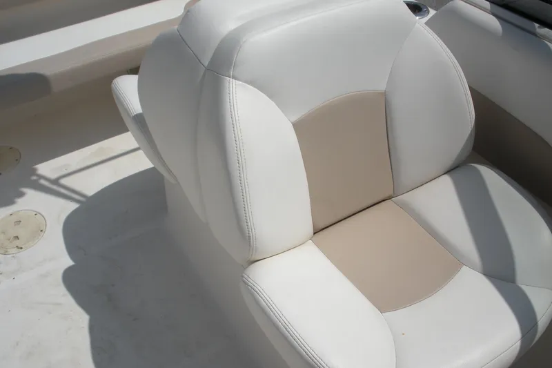 Slide: The Image of 2017 Robalo R227DC boat seat with white and beige upholstery. - 10