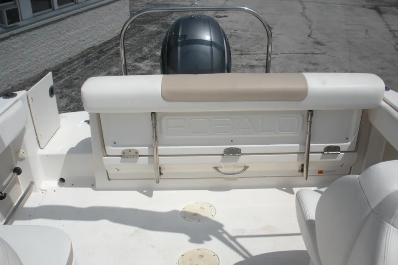 Slide: The Image of 2017 Robalo R227DC boat interior with seating and engine view. - 11