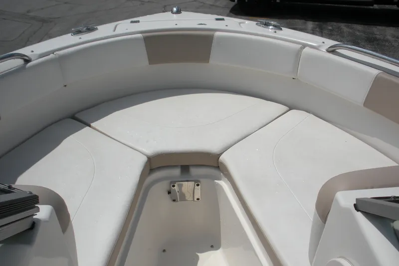 Slide: The Image of 2017 Robalo R227DC boat interior with cushioned seating in the bow area. - 4