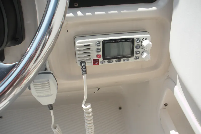 Slide: The Image of 2017 Robalo R227DC boat radio and steering wheel close-up. - 8
