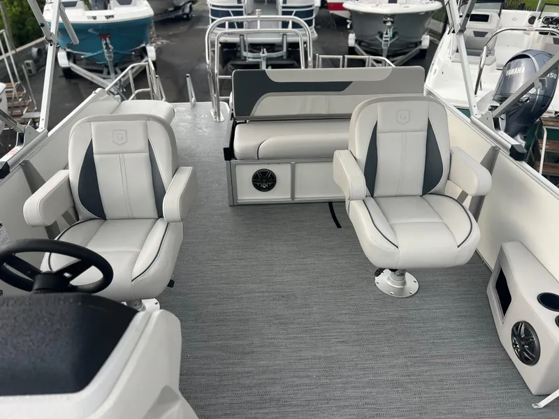 Slide: The Image of Interior of 2026 Sweetwater 2286SFLC boat with modern seating and steering wheel. - 11