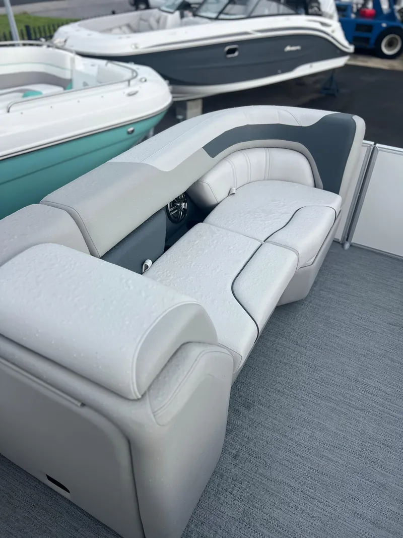 Slide: The Image of 2026 Sweetwater 2286SFLC boat interior with sleek, modern seating design. - 12