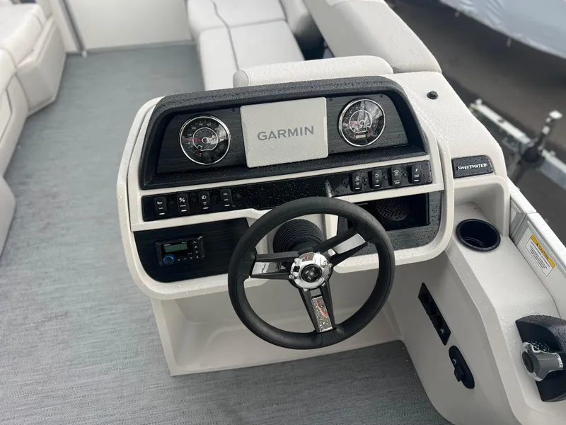 Slide: The Image of 2026 Sweetwater 2286SFLC boat dashboard with Garmin display and steering wheel. - 3