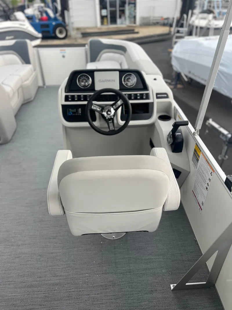 Slide: The Image of 2026 Sweetwater 2286SFLC boat helm with Garmin navigation system and comfortable seating. - 8