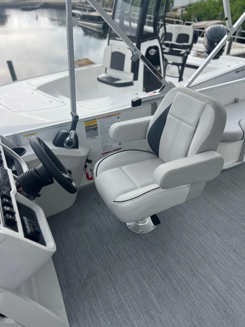 Slide: The Image of Captain's chair on 2026 Sweetwater 2286SFLC boat, featuring sleek design and modern controls. - 9