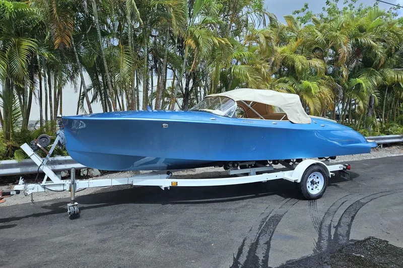 Slide: The Image of 2022 Seven Seas Yachts Hermes Speedster in blue on a trailer, surrounded by palm trees. - 8
