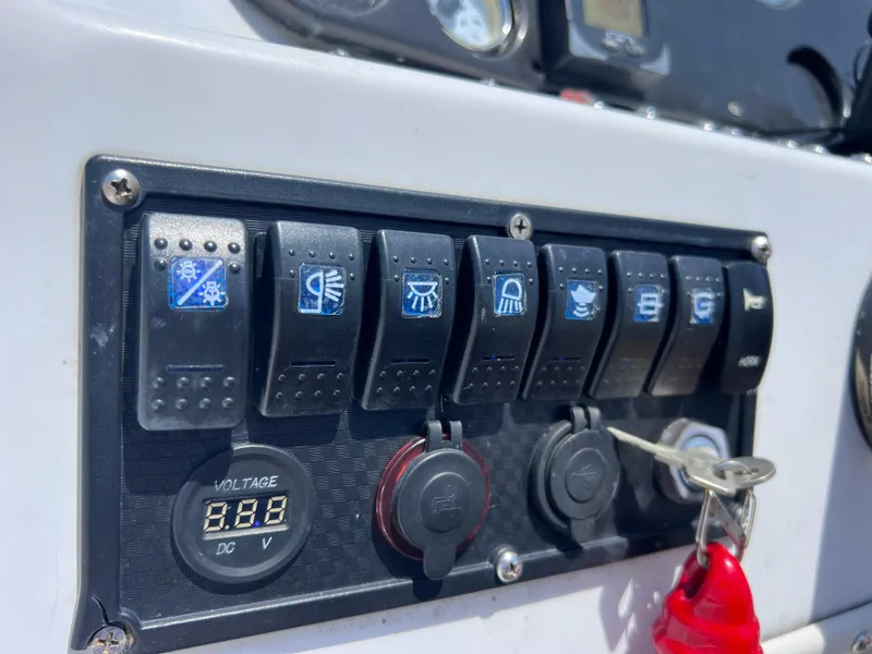 Slide: The Image of Control panel of a 2000 Hurricane FunDeck GS 232 OB boat with switches and voltage display. - 16