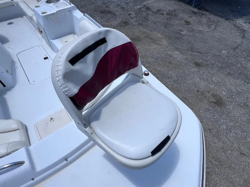 Slide: The Image of Boat seat on 2000 Hurricane FunDeck GS 232 OB, white with maroon accent, outdoor setting. - 19