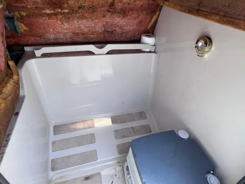 Slide: The Image of Interior of a 2000 Hurricane FunDeck GS 232 OB boat, featuring a compact storage area. - 21