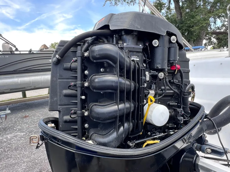 Slide: The Image of Close-up of a 2000 Hurricane FunDeck GS 232 OB outboard motor, showcasing engine details. - 22