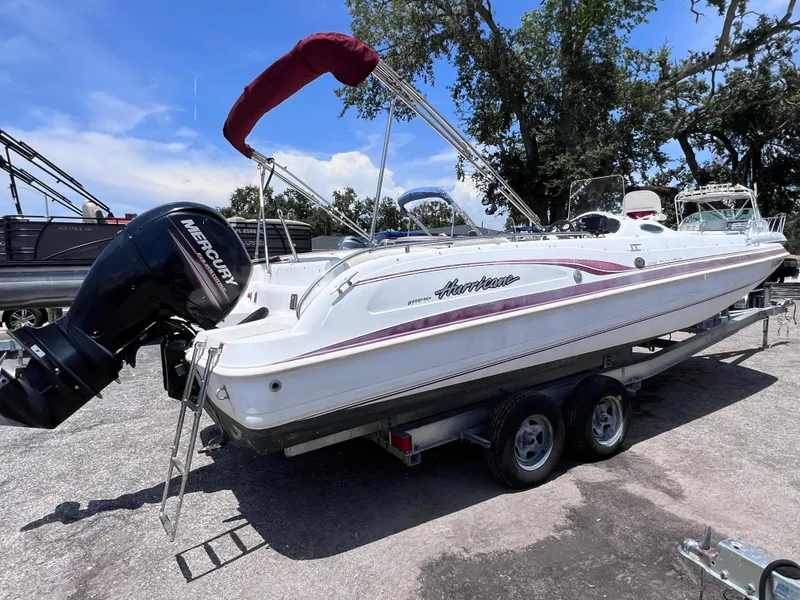 Slide: The Image of 2000 Hurricane FunDeck GS 232 OB boat on trailer, featuring Mercury outboard motor. - 7