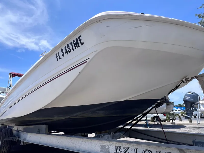 Slide: The Image of 2000 Hurricane FunDeck GS 232 OB boat on trailer, clear sky background. - 8