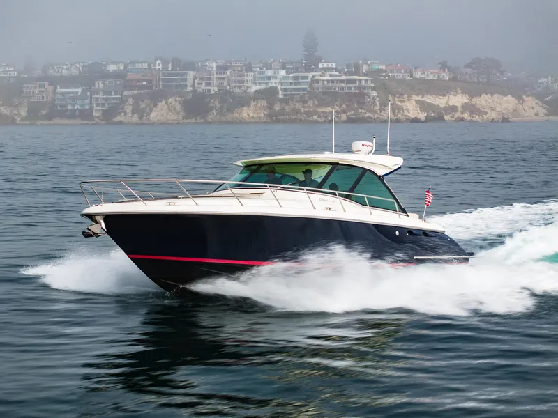 Slide: The Image of 2014 Chris-Craft Corsair 36 Hard Top cruising on the ocean near coastal homes. - 15