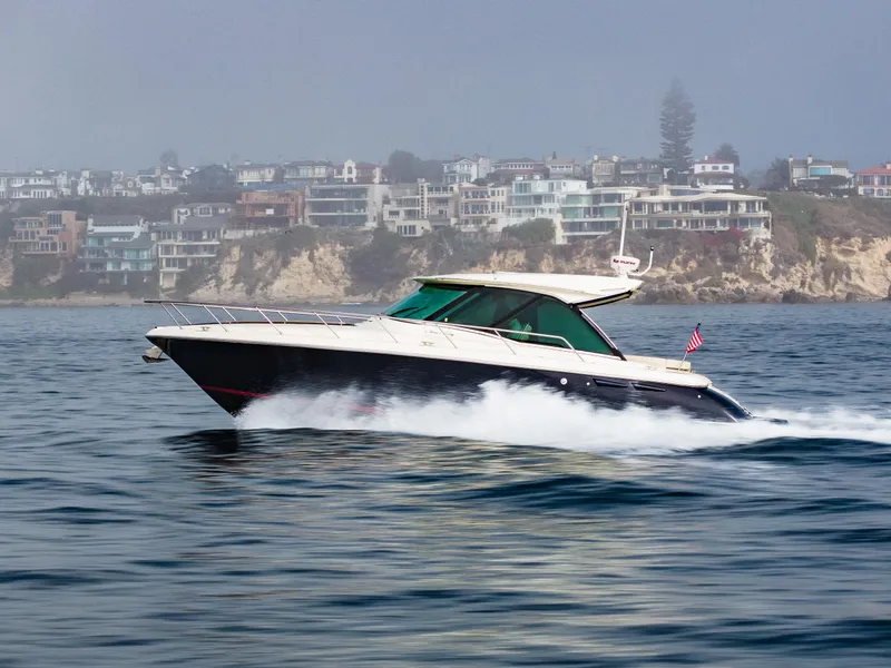 Slide: The Image of 2014 Chris-Craft Corsair 36 Hard Top cruising on ocean near coastal homes. - 17