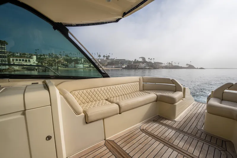 Slide: The Image of 2014 Chris-Craft Corsair 36 Hard Top boat interior with beige seating and ocean view. - 39