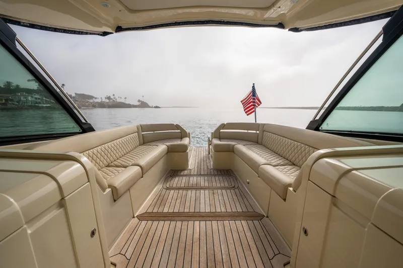 Slide: The Image of 2014 Chris-Craft Corsair 36 Hard Top interior with American flag, overlooking calm waters. - 40