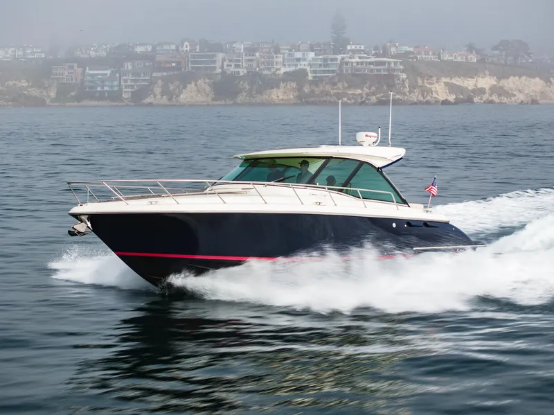 Slide: The Image of 2014 Chris-Craft Corsair 36 Hard Top cruising on the ocean near coastal homes. - 14