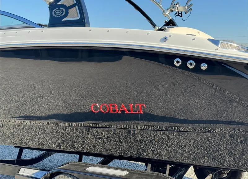 Slide: The Image of 2020 Cobalt R7 Surf boat with sleek black hull and red logo. - 2