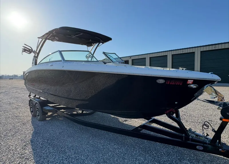 Slide: The Image of 2020 Cobalt R7 Surf boat on trailer, parked outdoors near storage units. - 5